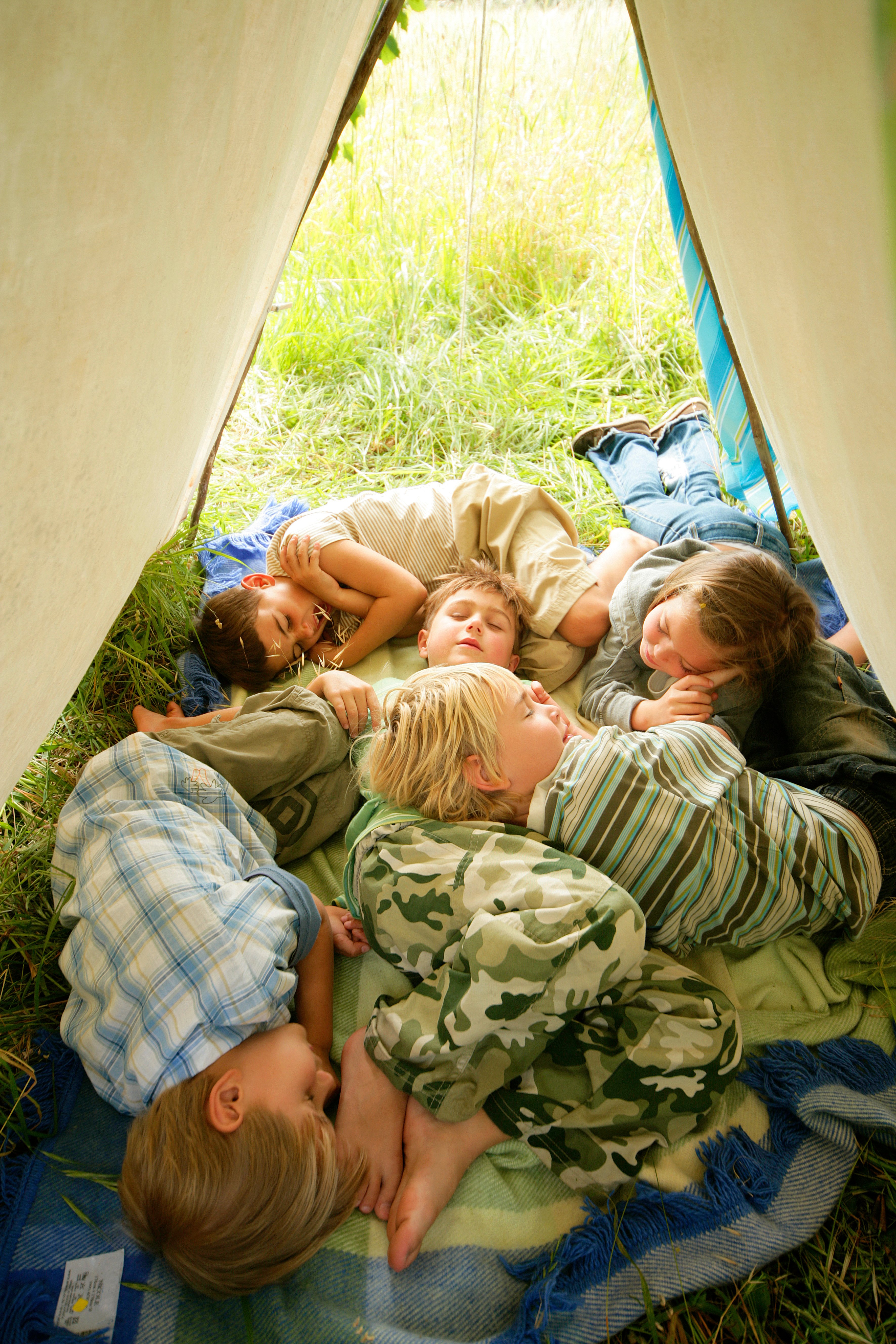 Young children sleeping in a tent